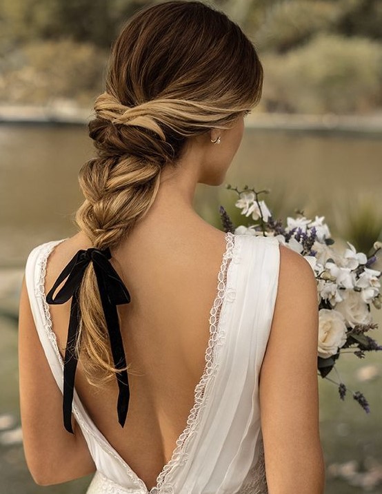 an elegant twisted braid with wavy ends and a black ribbon for an accent - it's a hot and trendy idea