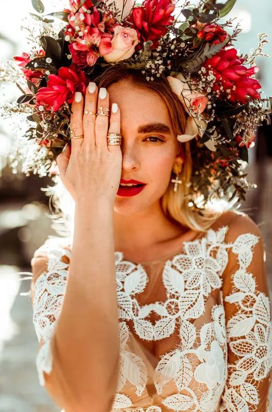 an oversized floral crown with blush, red and white blooms and textural greenery for a summer or  fall boho bride