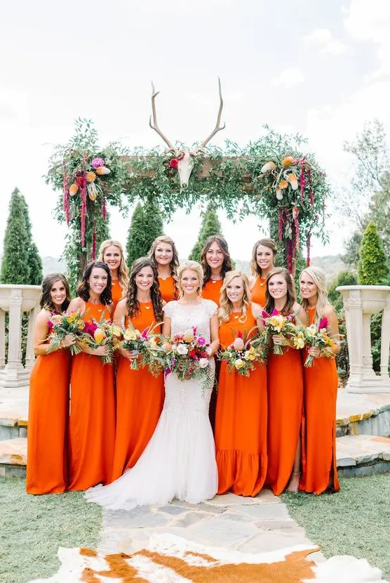 bold orange halter neckline maxi bridesmaid dresses for a colorful wedding with a desert feel