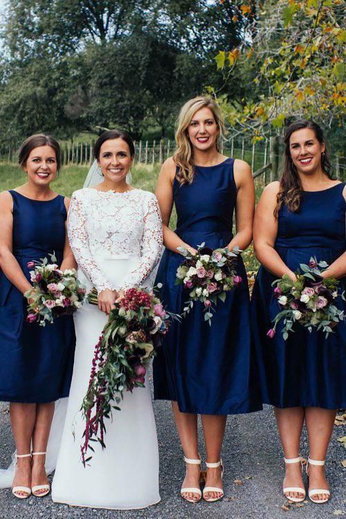 elegant navy A-line bridesmaid dresses with high necklines, no sleeves and pleated skirts are amazing for a retro wedding
