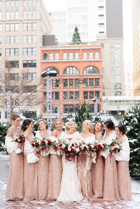 gorgeous rose gold maxi bridesmaid dresses paired with white pashminas to keep the bridesmaids warm