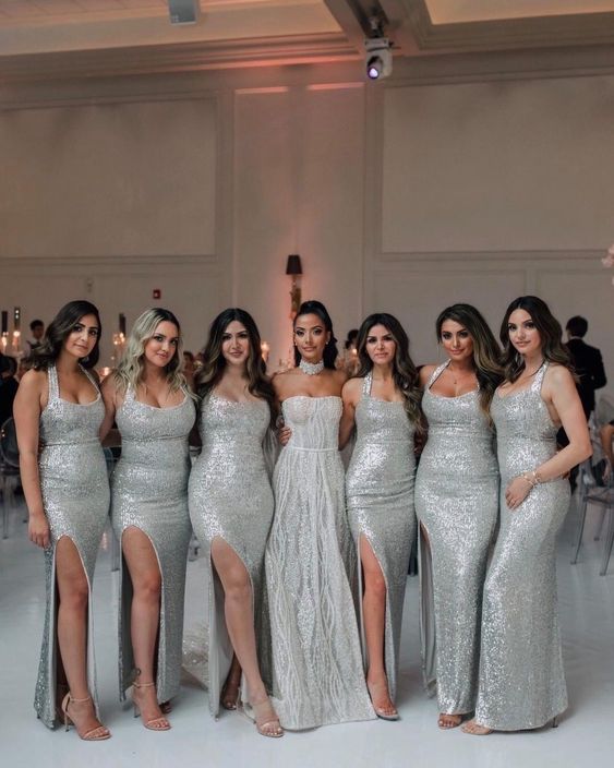 matching silver sequin maxi bridesmaid dresses with straps and slits are amazing for a glam and refined wedding
