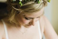 messy waves and a very delicate white floral, greenery and seed pod wedding floral crown for a spring bridal look