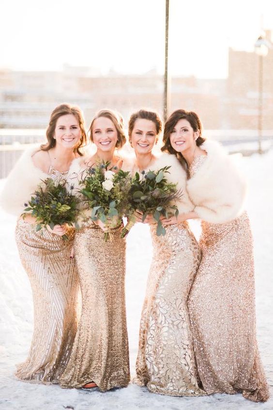 mismatched gold embellished and sequin maxi bridesmaid dresses with white faux fur shawls are pure elegance