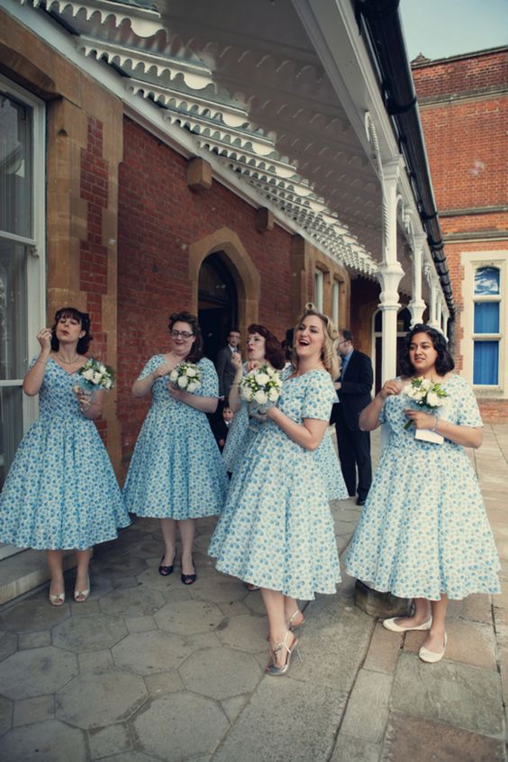mismatching blue polka dot 50s inspired bridesmaid dresses with short sleeves and V-necklines are wow