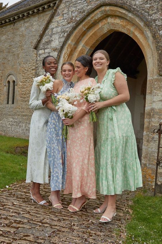 mismatching pastel floral midi bridesmaid dresses with various necklines and ruffles plus white slingbacks
