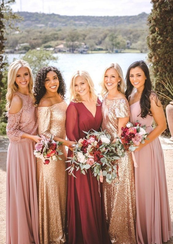 mix and match bridesmaid dresses in pink and gold and a burgundy dress for a bold wedding
