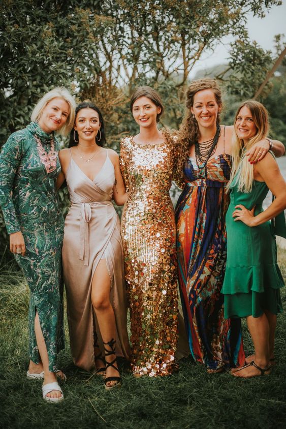 mix and match green and gold plus bright bridesmadi dresses wearing mismatching shoes for a bold eclectic wedding