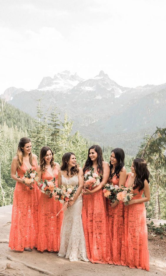 peachy pink maxi lace bridesmaid dresses with deep V-necklines and thick straps are lovely and bold for a summer wedding