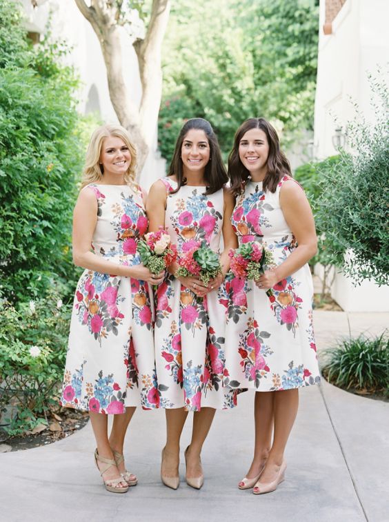 vintage sleeveless midi A-line bridesmaid dresses with bold floral prints will be a nice idea for a vintage or retro wedding