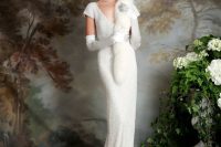 a 1920s embellished wedding dress with a V-neckline, short sleeves, a train, a faux fur scarf and an embellished headpiece plus statement earrings