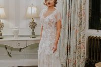 a 1920s glam lace embellished wedding dress of a mermaid silhouette, sheer cap sleeves and a deep V-neckline for a vintage wedding