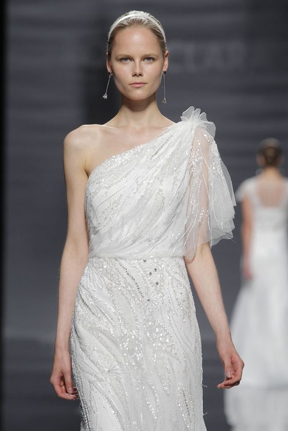 a beautiful fully embellished one shoulder wedding dress with a short sleeve is a lovely take on embellished 1920s wedding dresses
