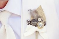 a beautiful wedding boutonniere of burlap, buttons, a heart rhinestone, feathers and a bow is a cool idea to make the groom’s look bolder and catchier