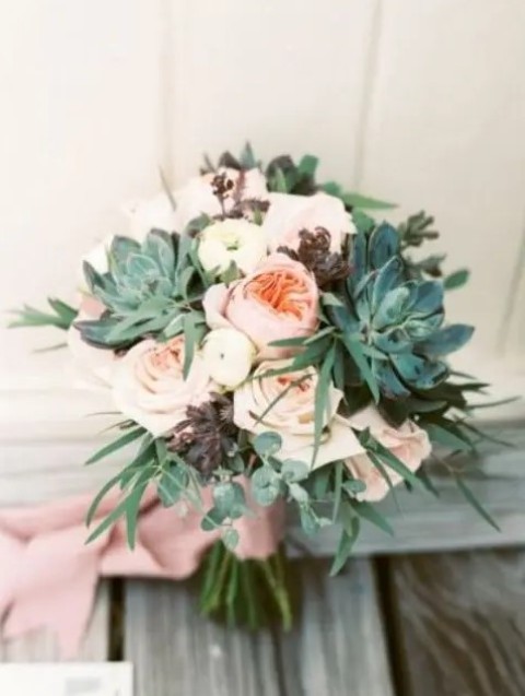 a blush nautical wedding bouquet of peonies and roses, succulents and dark and usual green foliage plus dusty pink ribbons