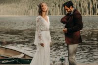 a boho lace A-line wedding gown with a V-neckline, bell sleeves and a train for a lake boho elopement