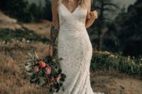 a boho lace fitting wedding dress on spaghetti straps and a train for a boho elopement