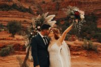 a boho lace fitting wedding gown on spaghetti straps with a train for a boho desert elopement