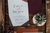 a bold and stylish wedding invitation suite with a burgundy envelope, painted burgundy ribbons