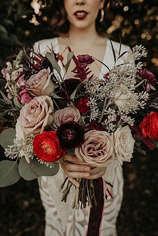 a bold fall wedding bouquet of hot red, lilac, white and deep purple blooms, greenery and seeded eucalyptus for a bold fall wedding