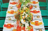 a bold orange fabric table runner and echoing glasses and menus for a bold autumn celebration