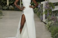 a bold plain one shoulder wedding dress with a thigh high slit and a lace insert on the side plus a train for a bold look
