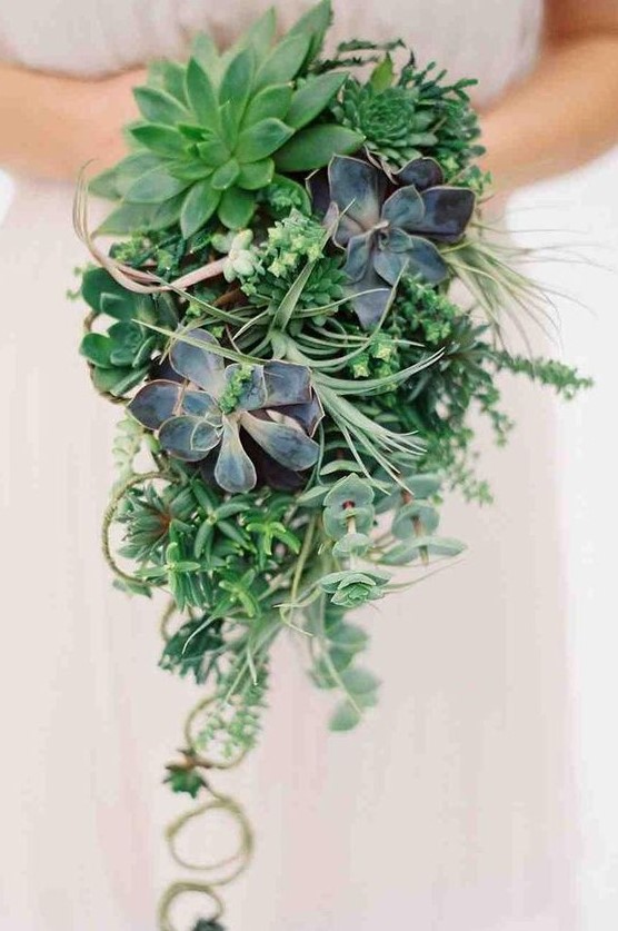a cascading greenery wedding bouquet with lots of succulents of various shades looks wow