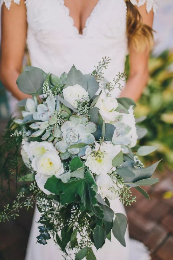 a cascading neutral wedding bouquet of white peony roses, succulents and greenery is a beautiful solution for a neutral wedding