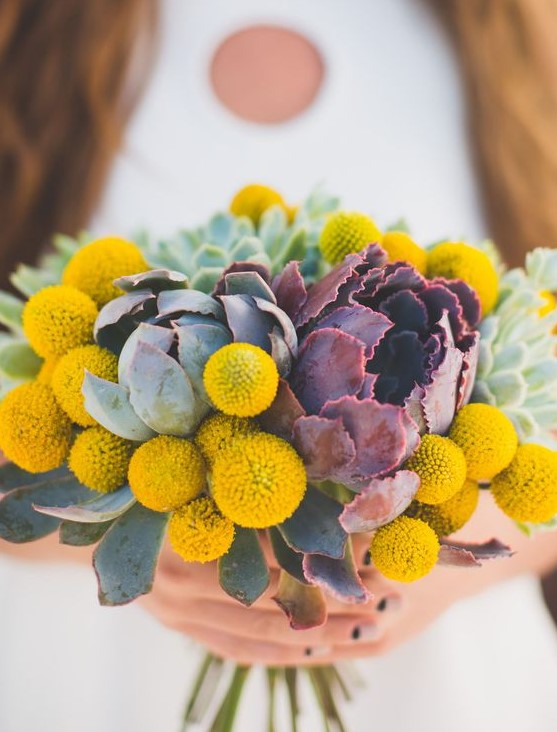 a cool wedding bouquet of billy balls and usual and dark succulents is a lovely idea for a mid-century modern wedding