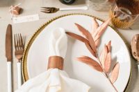a copper napkin ring is a bright and chic touch to the tablescape and matches the cutlery in the best way