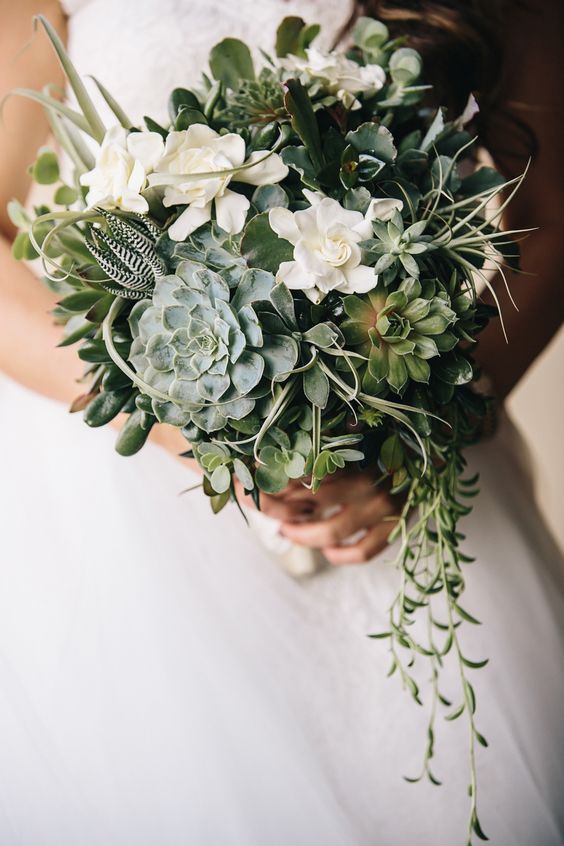 a creative wedding bouquet of white blooms, lots of various succulents and cascading greenery is a lovely and fresh idea