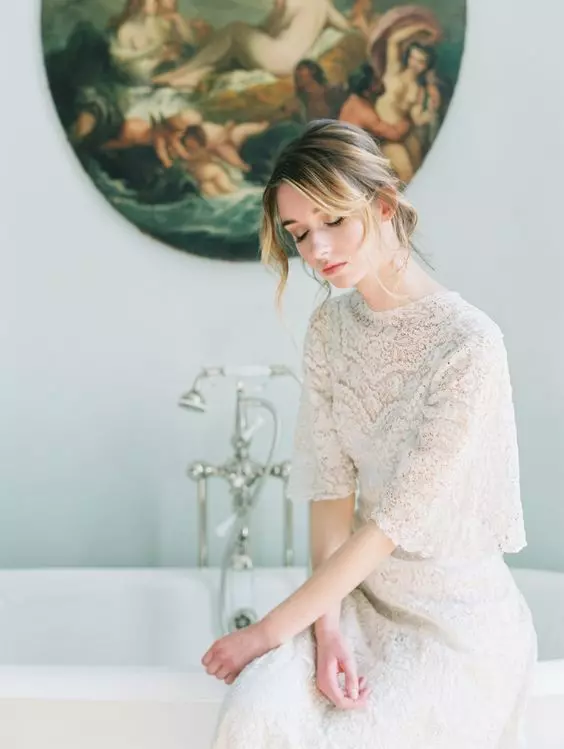 a delicate and refined lace wedding dress with a high neckline, bell sleeves is a very chic and stylish idea for a vintage-inspired bride