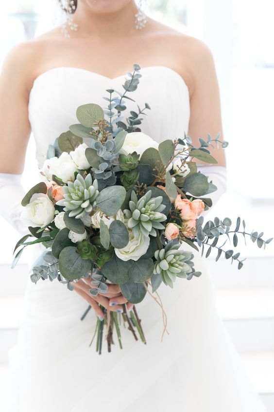 a dimensional wedding bouquet of white roses and peachy ones, eucalyptus and succulents is a lovely and pretty summer idea