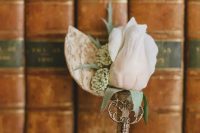 a fab vintage wedding boutonniere of a blush rose, greenery and a vintage key is a great groom’s accessory