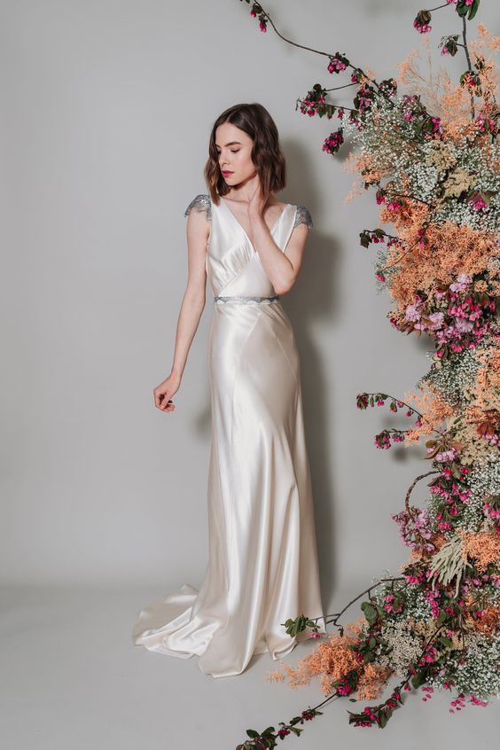 a fabulous 1920s inspired silkd semi-fitting dress with a V-neckline, embellished sleeves and a train plus an embellished sash