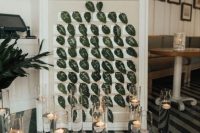 a framed seating chart with leaves and floating candles is a very refined and chic idea for the fall