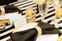 a glam gold rhinestone napkin ring perfectly matches the black, white and gold tablescape and highlights the glam feel