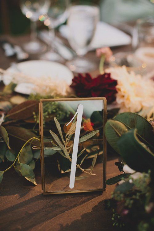 a glass framed table number with some greenery inside is a lovely idea for many types of fall weddings