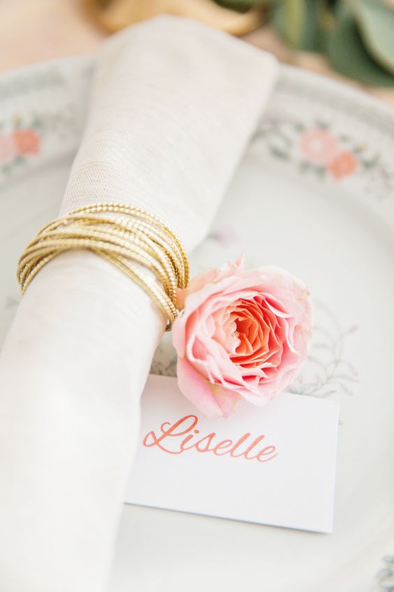a gold cord and a pink flower are great as a delicate and chic accent to your tablescape, will do for a spring or summer wedding
