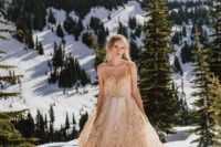a gold wedding ballgown with an illusion neckline for a winter mountain elopement looks wow