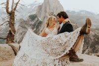 a gorgeous boho lace wedding dress with thick straps and a V-neckline, hiking boots for a mountain elopement