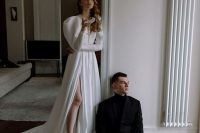 a gorgeous modern yet vintage-inspired plain wedding dress, a plunging neckline, puff sleeves, a thigh high slit, a train is amazing
