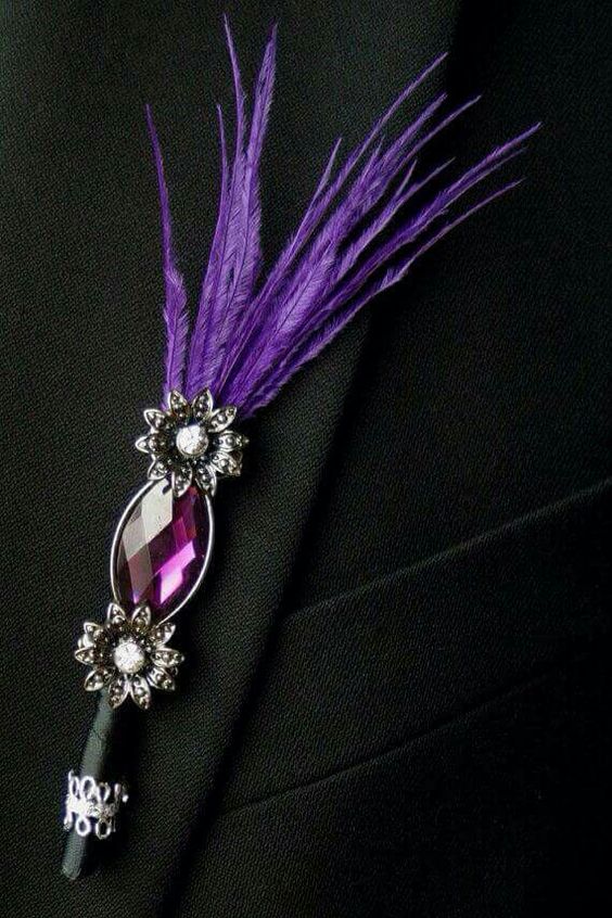 a gorgeous wedding boutonniere of a pink rhinestone, mini flowers and purple feathers will give a creative touch to the look and will add color