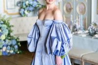 a jaw-dropping Bridgerton-inspired bridal look with a gorgeous royal blue off the shoulder wedding dress with a corset and puff sleeves