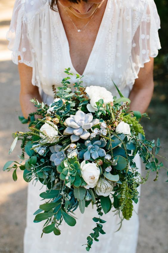 a lovely and vivacious wedding bouquet of white ponies, succulents and greenery is a beautiful solution for any season