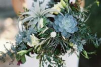 a lush greenery wedding bouquet with succulents and air plants, greenery and some white blooms is a stylish idea