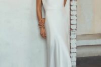 a minimalist plain one shoulder semi-fitting wedding dress with a train is ultimate elegance in modern style