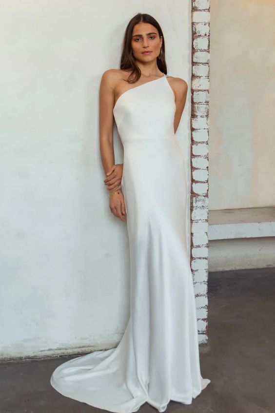 a minimalist plain one shoulder semi-fitting wedding dress with a train is ultimate elegance in modern style