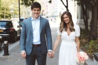 a modern city hall elopement wedding dress – a white wrap dress with a ruffle edge, pink mules for a trendy look