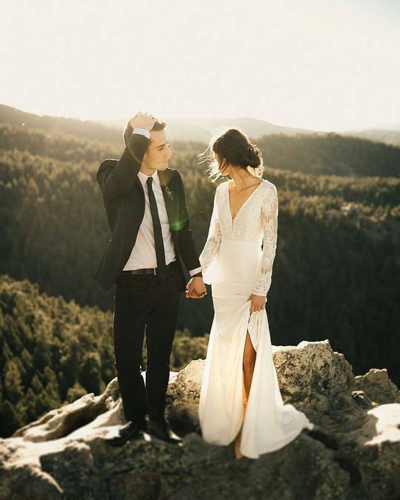 a modern lace A-line wedding dress with a V-neckline, long sleeves and a slit for a mountain elopement